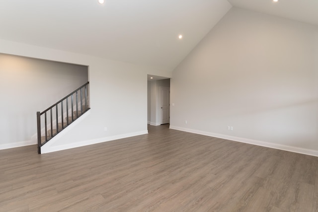 unfurnished living room featuring light hardwood / wood-style floors and high vaulted ceiling