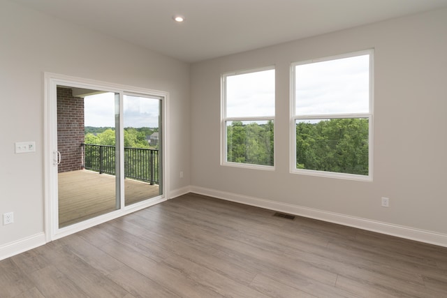 spare room with light hardwood / wood-style flooring