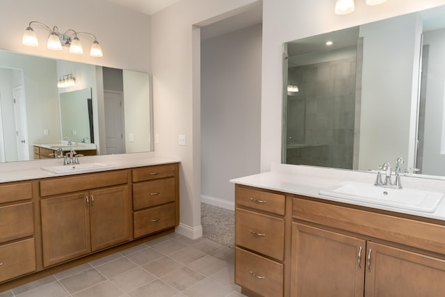 bathroom featuring vanity, tile patterned floors, and tiled shower