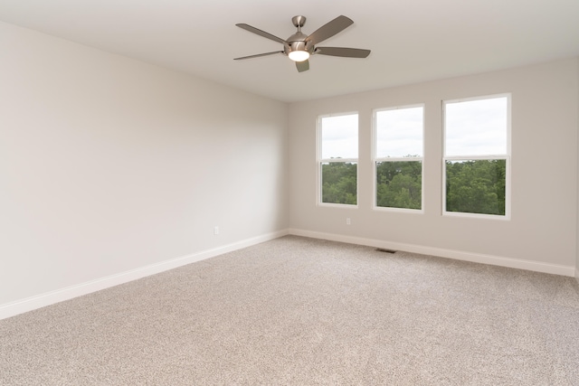 unfurnished room with ceiling fan and carpet flooring