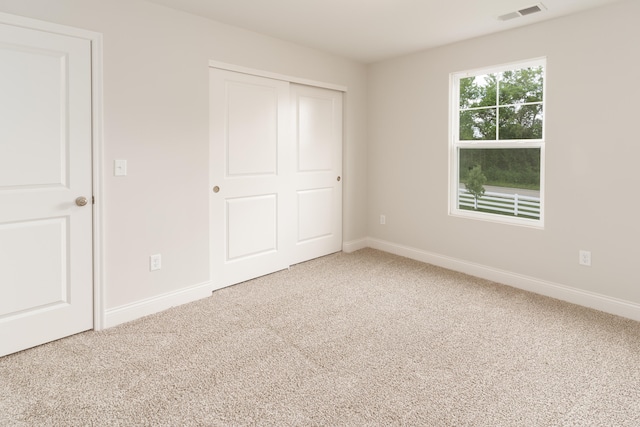 unfurnished bedroom featuring a closet and carpet