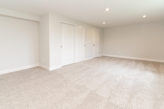 unfurnished bedroom with carpet flooring and two closets