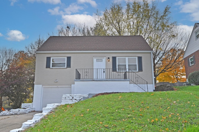 view of front of home with a garage and a front yard