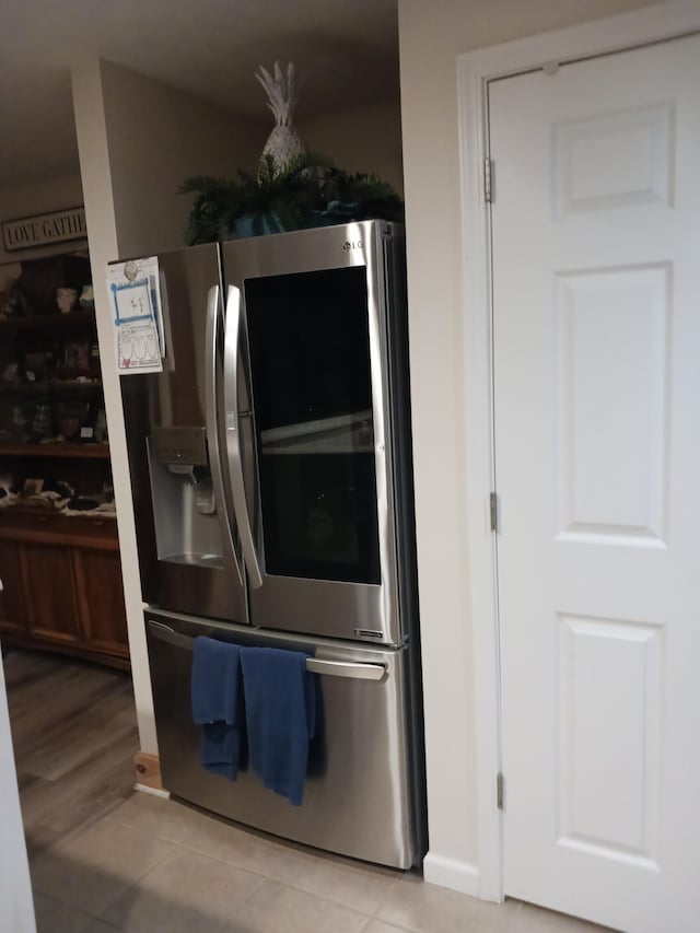 kitchen with light hardwood / wood-style floors and stainless steel fridge