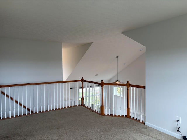 corridor featuring high vaulted ceiling and carpet floors