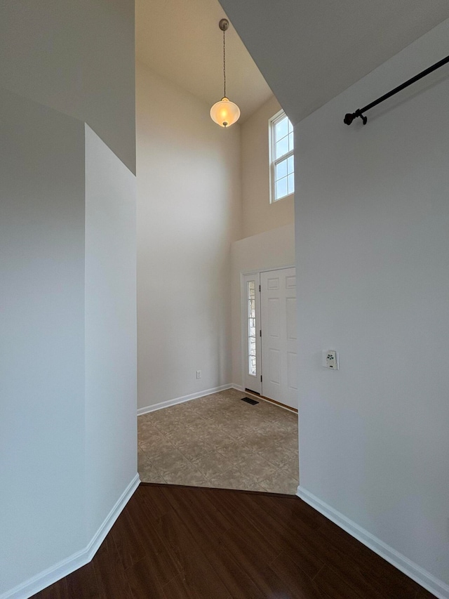 entryway featuring a high ceiling and hardwood / wood-style flooring