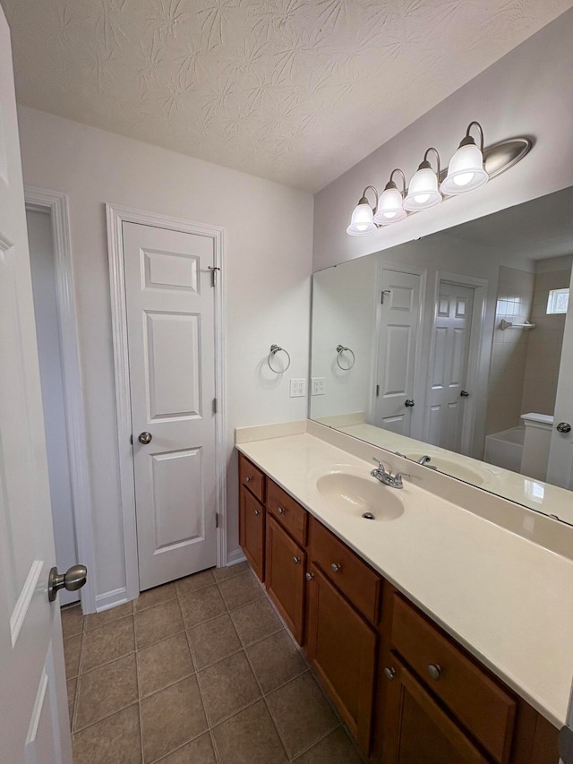 bathroom featuring vanity, a textured ceiling, and tile patterned floors