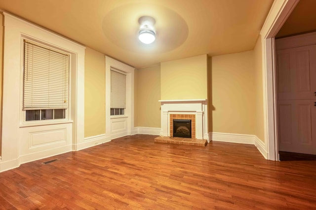 unfurnished living room featuring a fireplace and hardwood / wood-style flooring