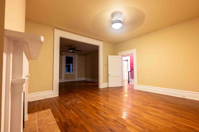 unfurnished living room featuring hardwood / wood-style flooring and ceiling fan