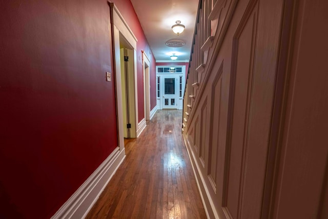 hall with wood-type flooring