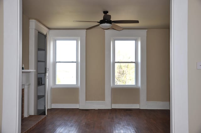 spare room with ceiling fan and dark hardwood / wood-style floors