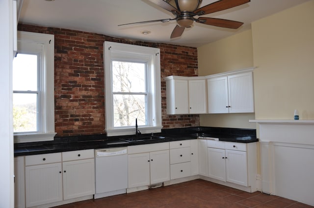 kitchen with white dishwasher, a healthy amount of sunlight, and white cabinets