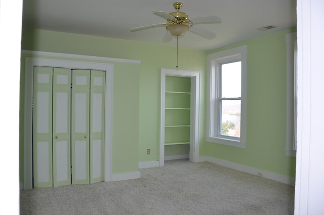 unfurnished bedroom with light carpet and ceiling fan