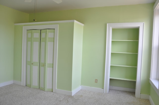 unfurnished bedroom with light carpet, ceiling fan, and a closet