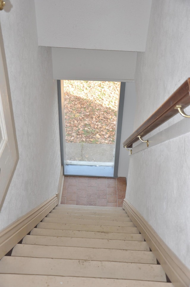 stairs featuring hardwood / wood-style flooring