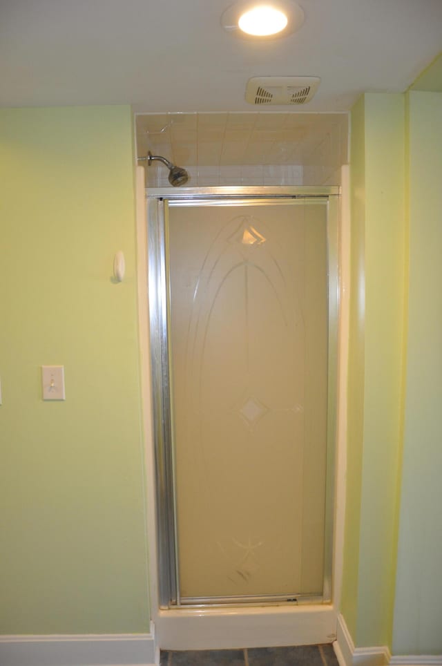 bathroom with a shower with shower door