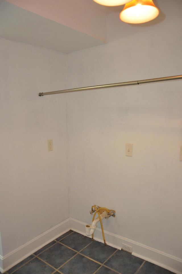 washroom featuring dark tile patterned flooring