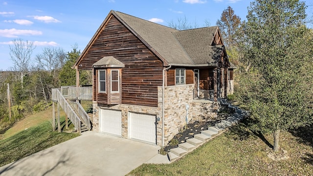 view of side of property with a deck and a garage