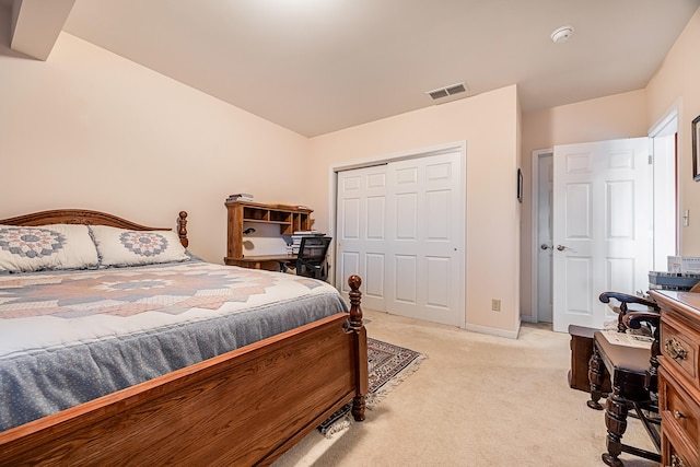 bedroom featuring light carpet and a closet