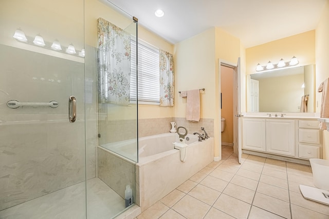 full bathroom with tile patterned flooring, shower with separate bathtub, toilet, and vanity