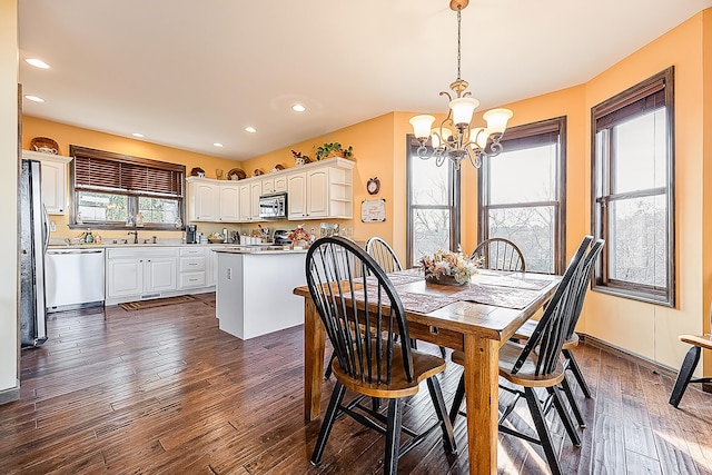 dining room featuring an inviting chandelier and dark hardwood / wood-style flooring