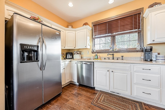 kitchen featuring stainless steel appliances, white cabinetry, sink, and dark hardwood / wood-style flooring