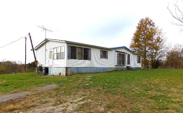 view of side of property with a yard