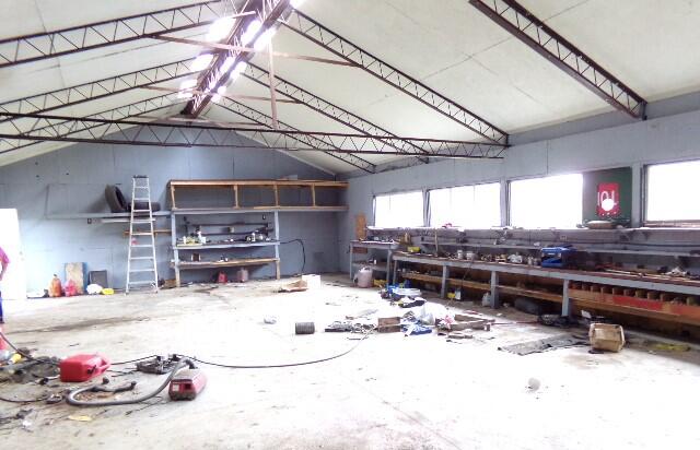 miscellaneous room with a healthy amount of sunlight, lofted ceiling, and concrete floors