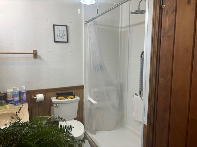 bathroom with walk in shower and toilet