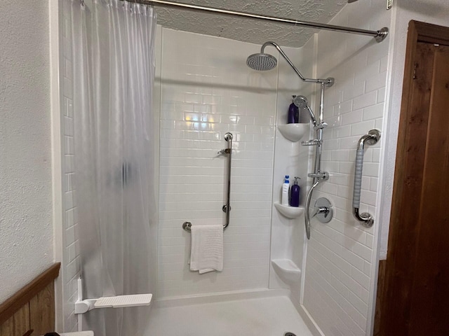 bathroom featuring a textured ceiling and curtained shower