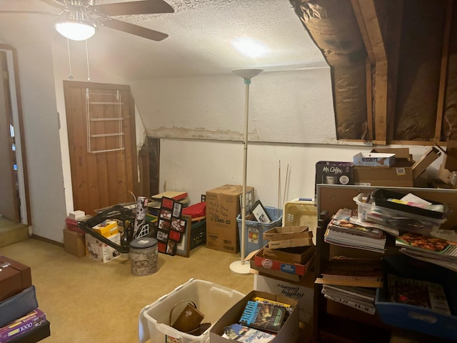 interior space with ceiling fan, a textured ceiling, and carpet