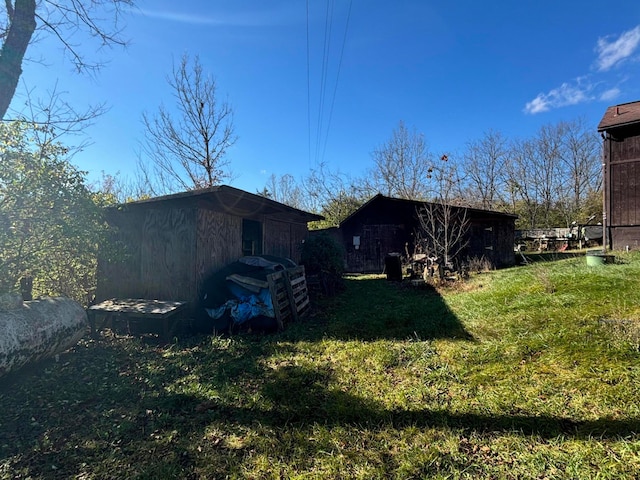 exterior space with a lawn and an outbuilding