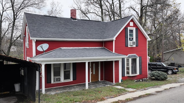 view of front of house featuring cooling unit and covered porch