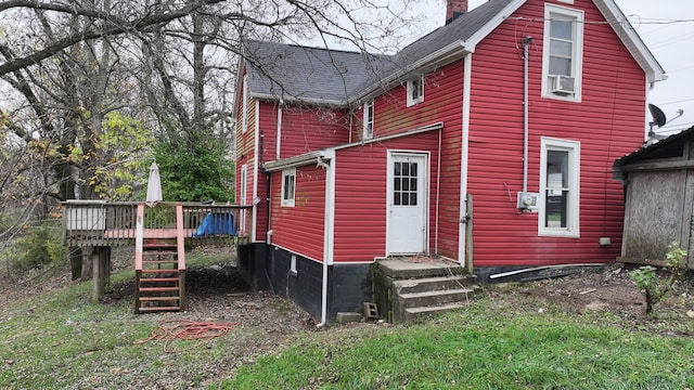 rear view of property with a deck