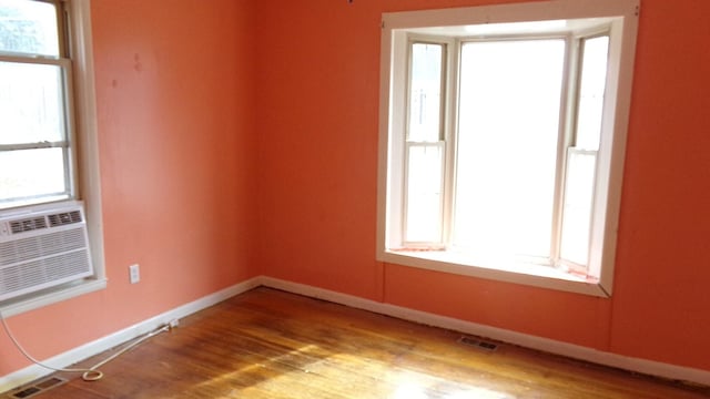 spare room with light wood-type flooring and cooling unit