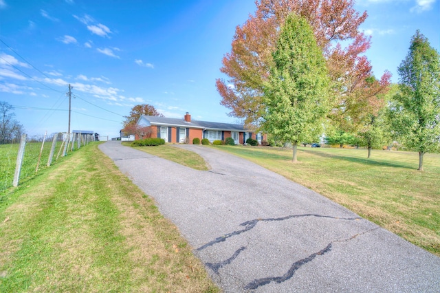 ranch-style home with a front yard