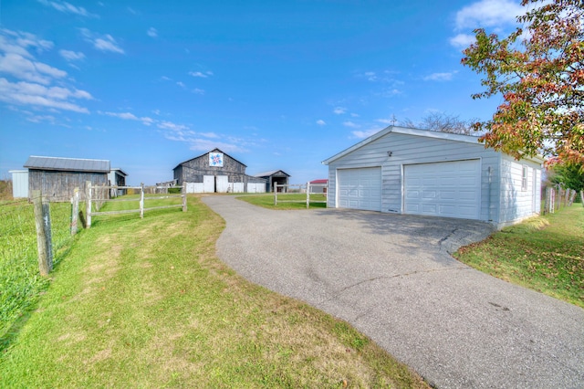 exterior space with an outbuilding and a garage