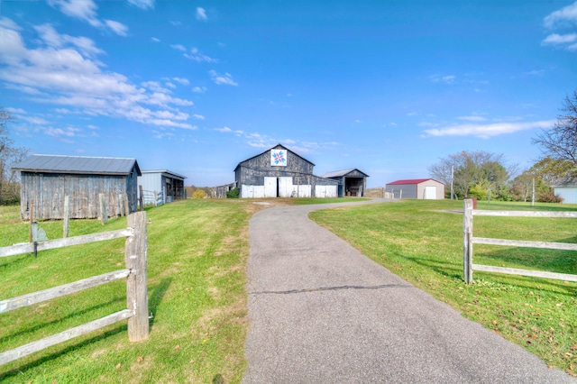 view of front of property featuring a front yard and an outdoor structure