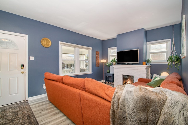 living room with a fireplace and light hardwood / wood-style flooring