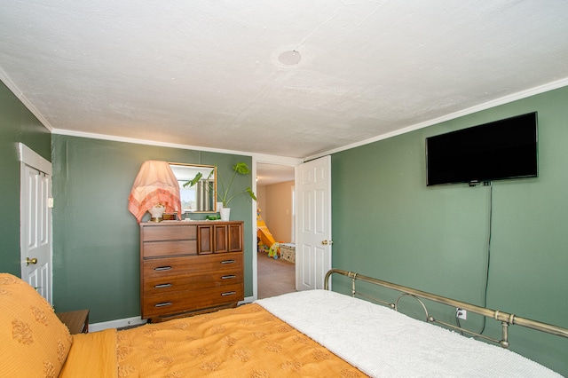 bedroom with hardwood / wood-style flooring, a textured ceiling, and ornamental molding