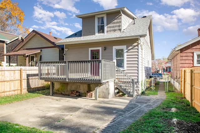 back of house with a wooden deck