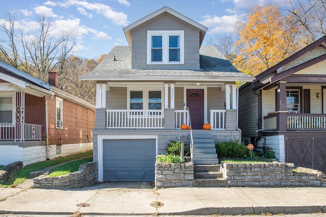 bungalow with covered porch and a garage