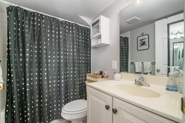 bathroom with vanity, toilet, and walk in shower