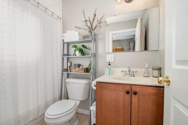 bathroom featuring tile patterned flooring, vanity, toilet, and walk in shower