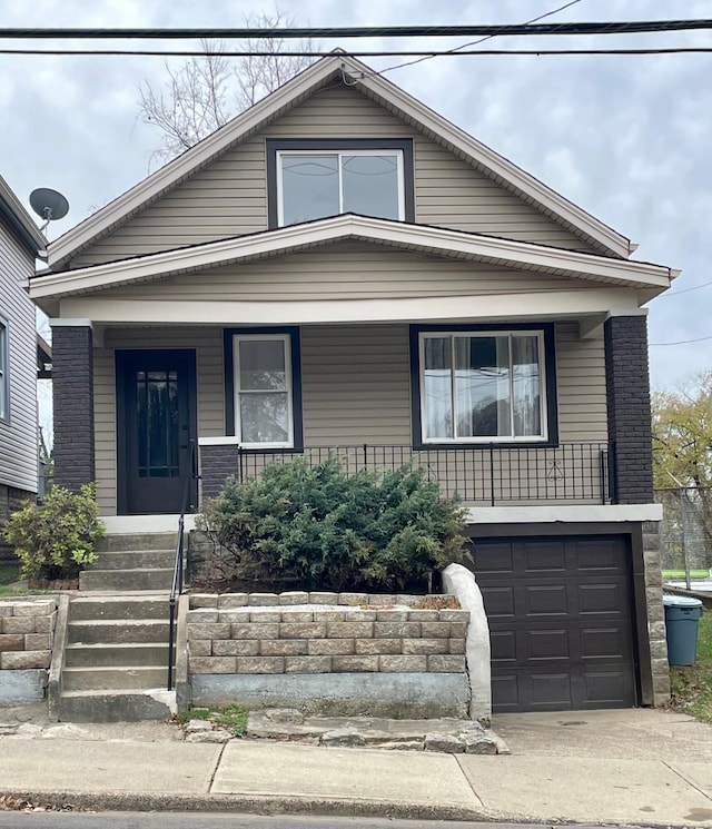 view of front of home featuring a garage and a porch