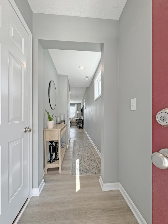 corridor with light wood-type flooring