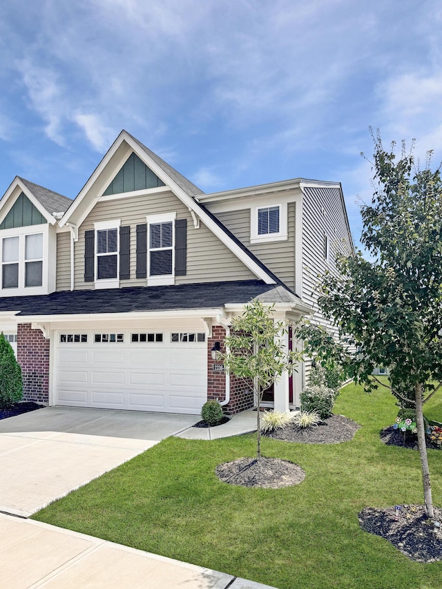 view of front of home featuring a front lawn and a garage