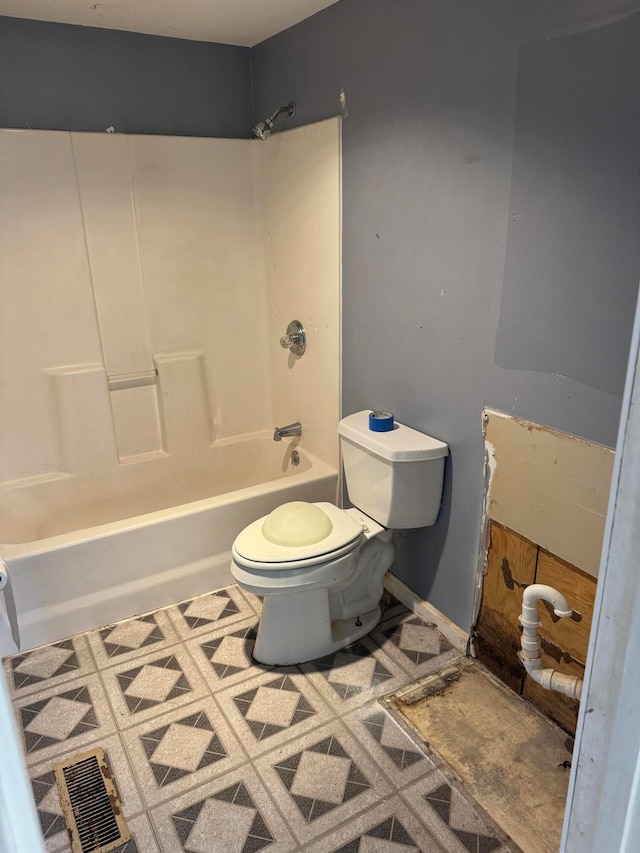 bathroom with tile patterned flooring, toilet, and tub / shower combination