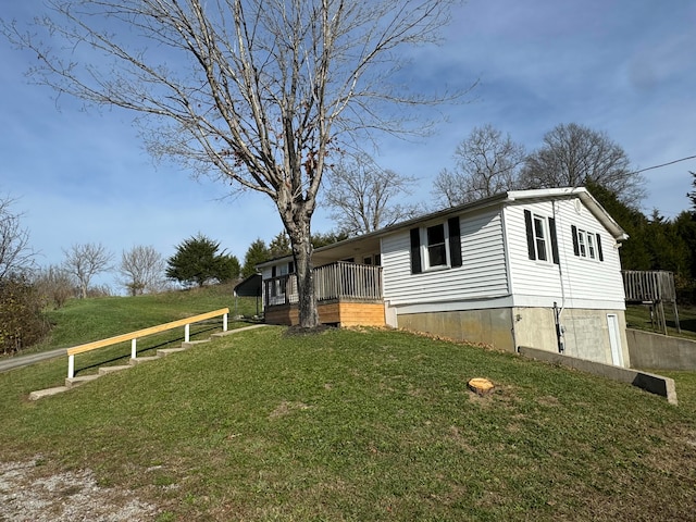 view of side of property featuring a deck and a yard