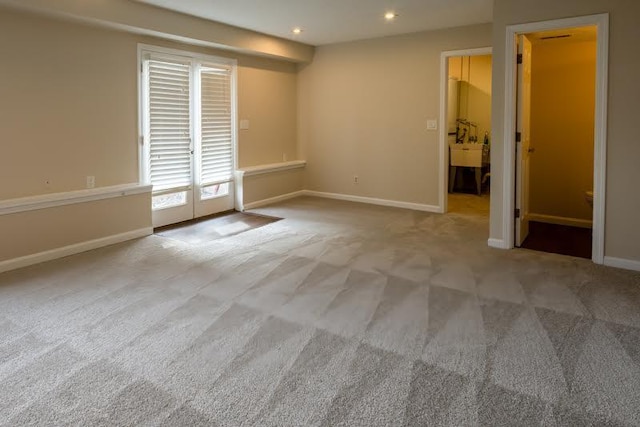 carpeted spare room featuring recessed lighting and baseboards